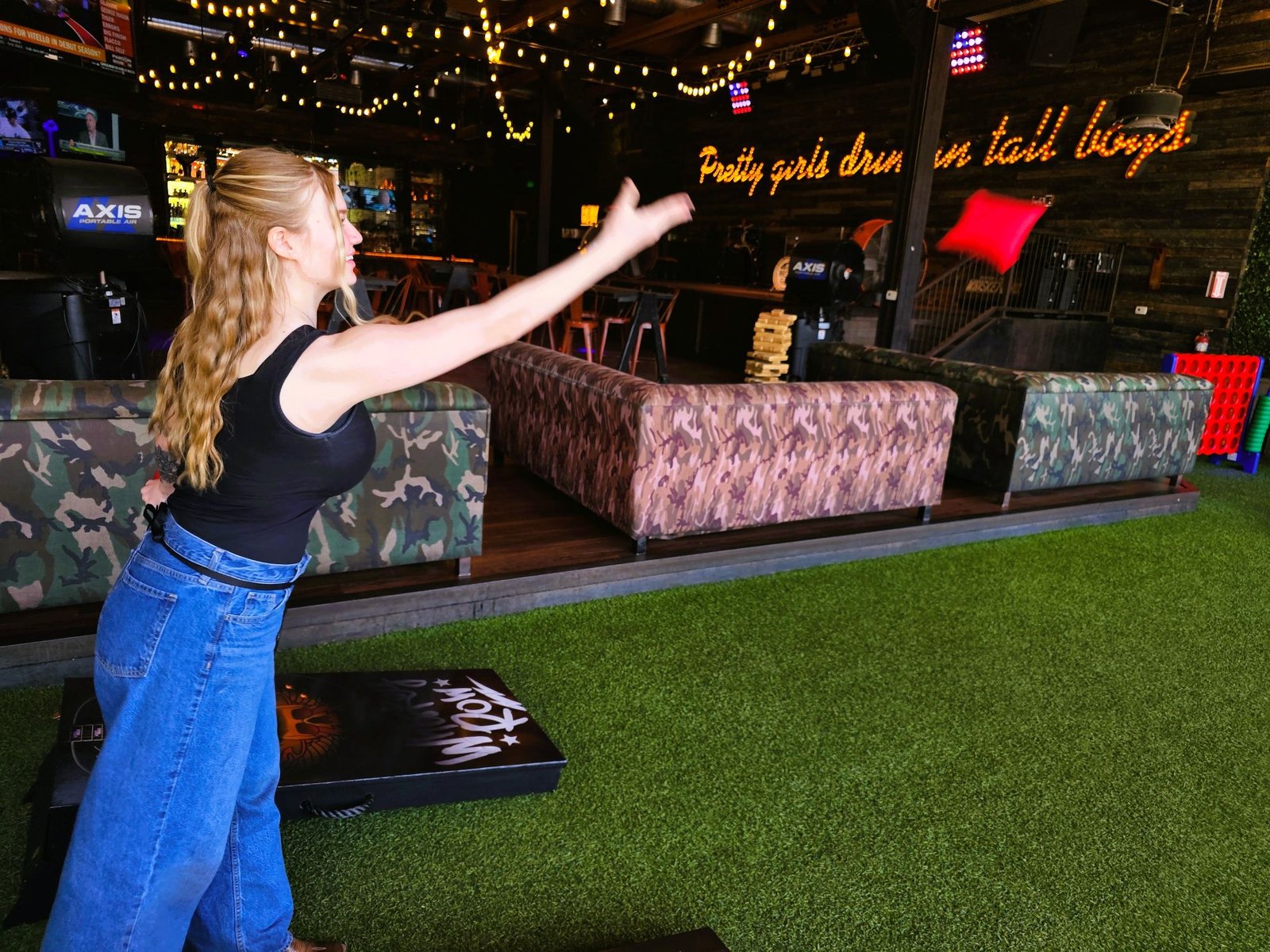 Guest playing cornhole at Dierks Bentley's Whiskey Row in Gilbert Arizona